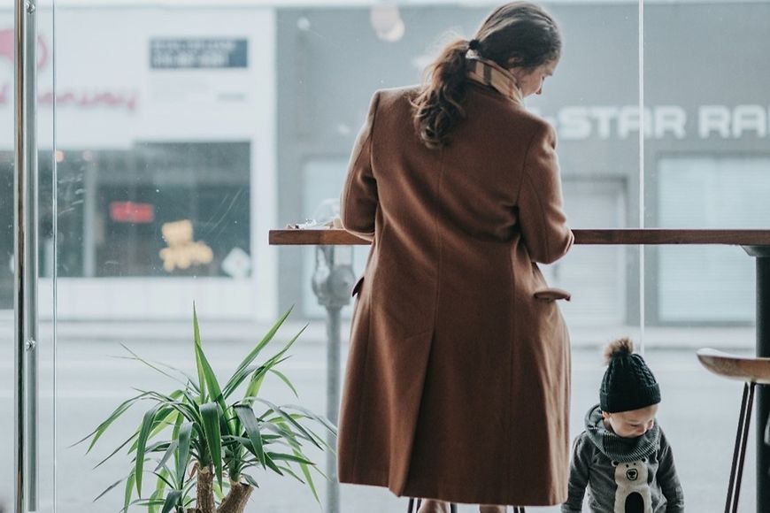 Frau mit kleinem Kind am Tisch